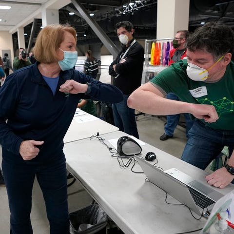 Seattle Mayor Jenny Durkan, left, greets a worker 