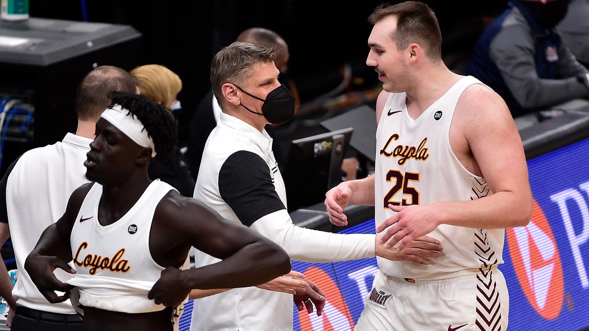 Loyola Ramblers center Cameron Krutwig (25) is congratulated by head coach Porter Moser after he was taken out of the game during the second half against the Indiana State Sycamores in the semifinals of the Missouri Valley Conference Tournament at Enterprise Center.