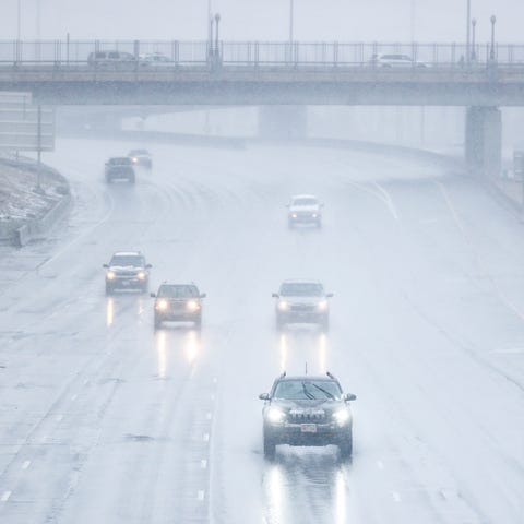 Cars drive along I-25 as it starts to snow on Marc