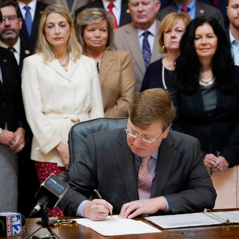 Mississippi Gov. Tate Reeves signs the first state