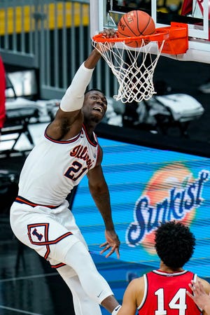 Illinois center Kofi Cockburn (21) goes up for a dunk against Ohio State in an NCAA college basketball championship game at the Big Ten Conference tournament in Indianapolis, Sunday, March 14, 2021. (AP Photo/Michael Conroy)