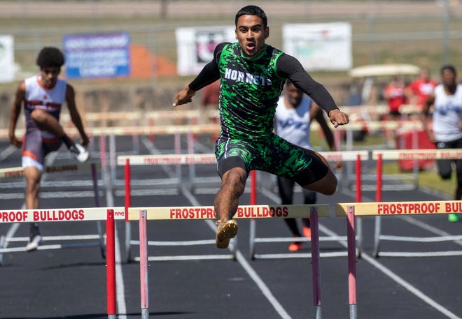 Haines City's Nathan Bowers goes over the last hurdle en route to winning the 300 hurdles on Saturday at The Ridge Championship at Frostproof High School. 