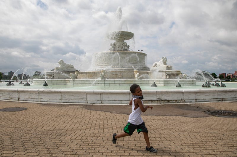 Jayden Poe, 5, of Detroit, runs around the James Scott Memorial Fountain that opened officially on Belle Isle on May 29, 2020.