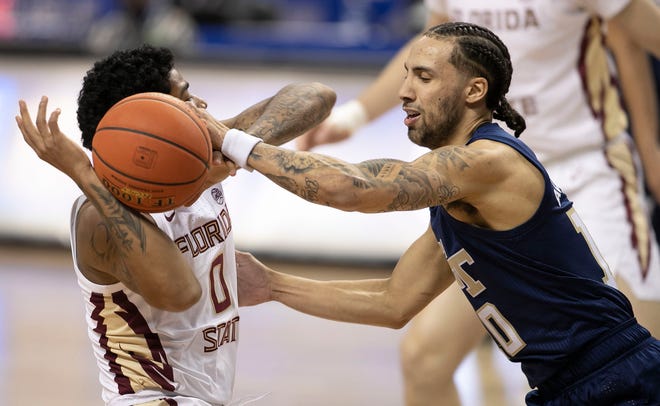 Georgia Tech’s Jose Alvarado (10 forces a turnover by Florida State’s Rayquan Evans (0) during the first half on Saturday, March 13, 2021 during the championship game of the  ACC Tournament at the Greensboro Coliseum in Greensboro, N.C. 