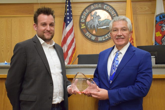 Doña Ana County Manager Fernando R. Macias, right, receives NMIDEA 2020 Ben Lujan Public Servant of the Year Award from Eric Montgomery, MVEDA vice president, business development.