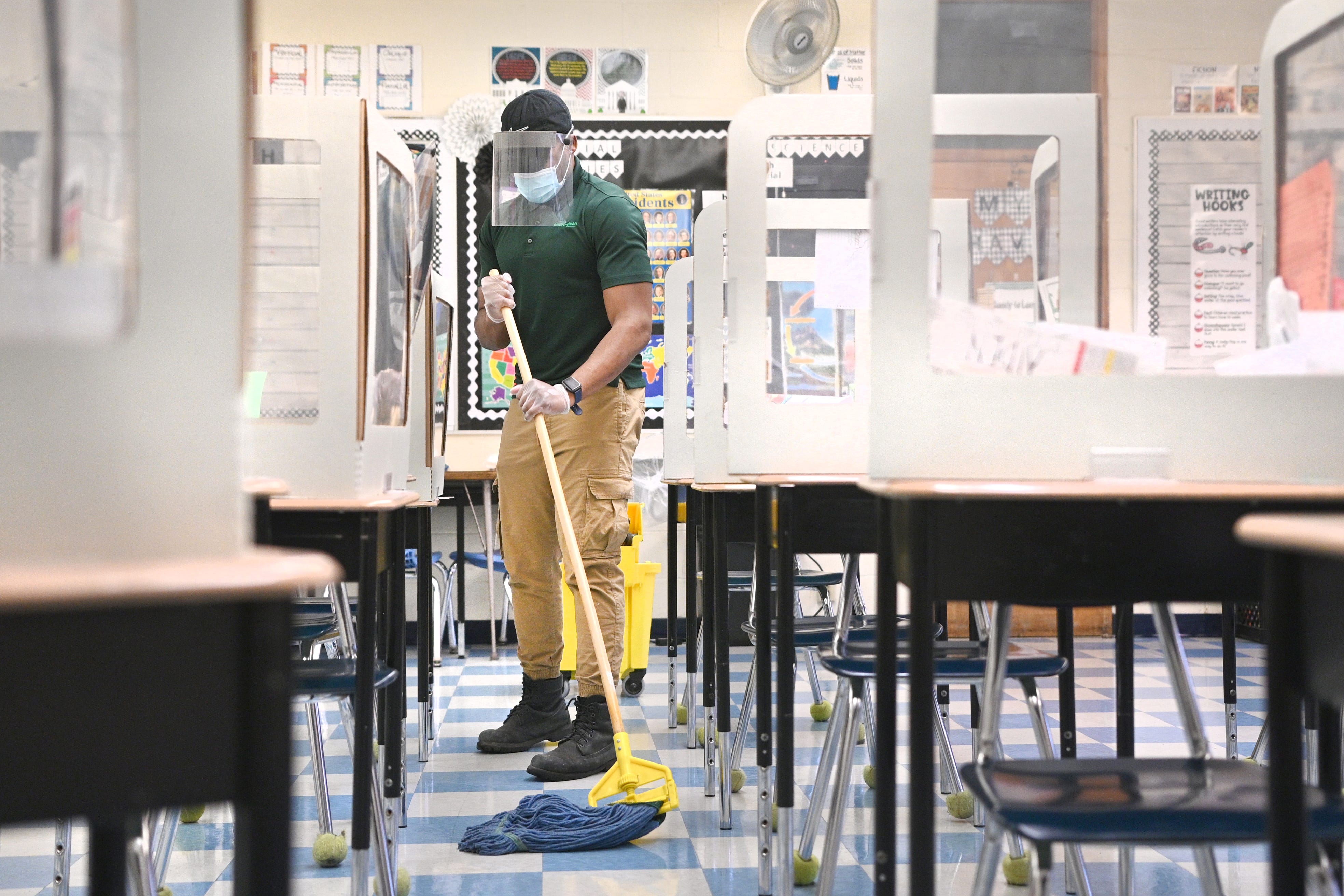 Johnathan Land mops a classroom floor at Bedford Elementary School in Dearborn Heights