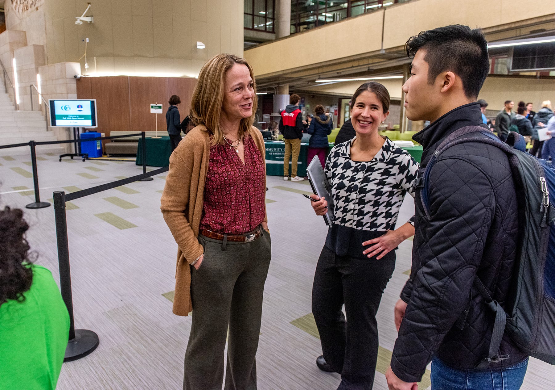 College of Rhode Island President Meghan Hughes, left, and Sara Enright, vice president of Student Affairs and chief outcomes officer, talk with student Andrew Lee during a campus open house event in 2019.