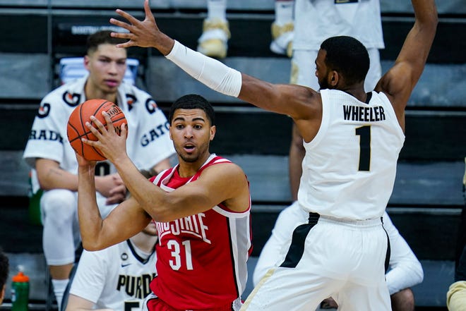 Ohio State forward Seth Towns (31) is pressured by Purdue forward Aaron Wheeler (1) in the second half of an NCAA college basketball game at the Big Ten Conference tournament in Indianapolis, Friday, March 12, 2021. Ohio State defeated Purdue 87-78 in overtime. (AP Photo/Michael Conroy)