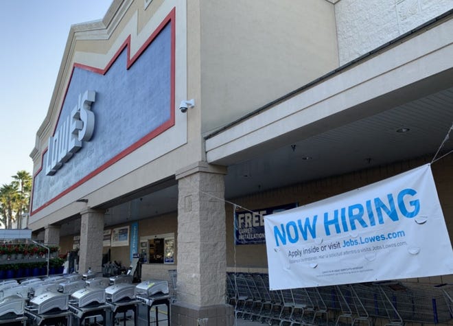 A hiring banner can be seen in front of the Lowe's Home Improvement store on Dunlawton Avenue in Port Orange on Saturday, Feb. 27, 2021.