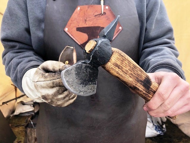 Nicholas Riolo, 17, of Bellingham, shows a hatchet he crafted in his backyard forge. The hatchet head is affixed to an antique wooden handle.