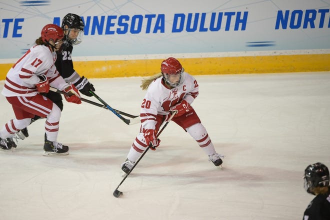 Wisconsin forward Brette Pettet (20) fires a shot and scores in the first period during the Badgers' victory over Providence in an NCAA Tournament quarterfinal game.