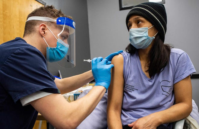 Edith Arangoitia is vaccinated with the Pfizer-BioNTech Covid-19 vaccine at La Colaborativa in Chelsea, Massachusetts on Feb. 16.