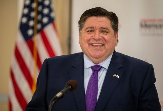 Gov. JB Pritzker smiles as he jokes with a reporter about giving them a scoop before others while answering questions during a press conference at the Abraham Lincoln Memorial Hospital in Lincoln on March 17. [Justin L. Fowler/The State Journal-Register]