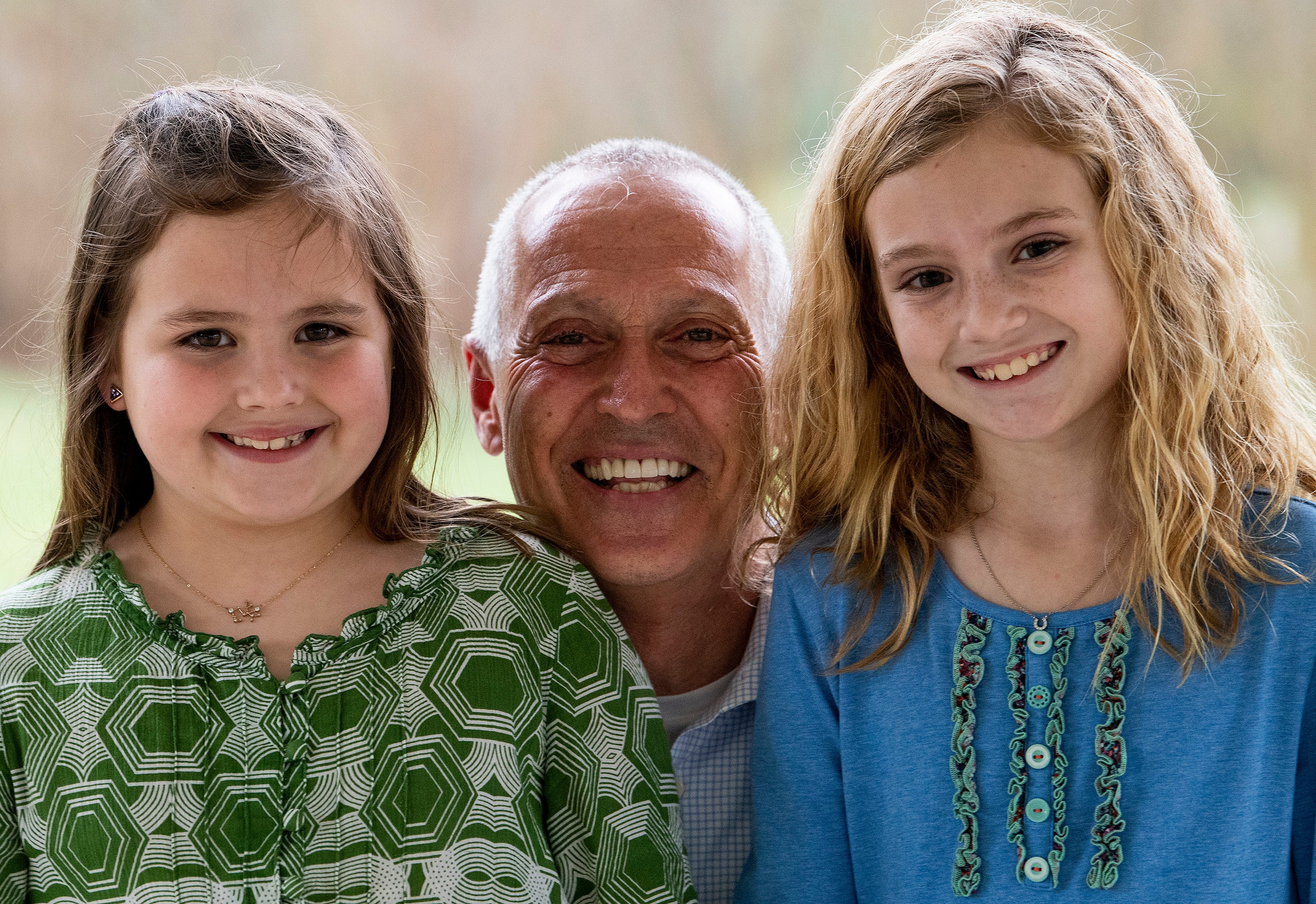 Tom Pieplow smiles with his granddaughters Mallory Sharman, left, and Ella Peyton Sharman, right, at Kiesel Park in Auburn, Ala., on Tuesday March 16, 2021. Pieplow recently received his COVID19 vaccines and can once again spend time with his grandchildren.