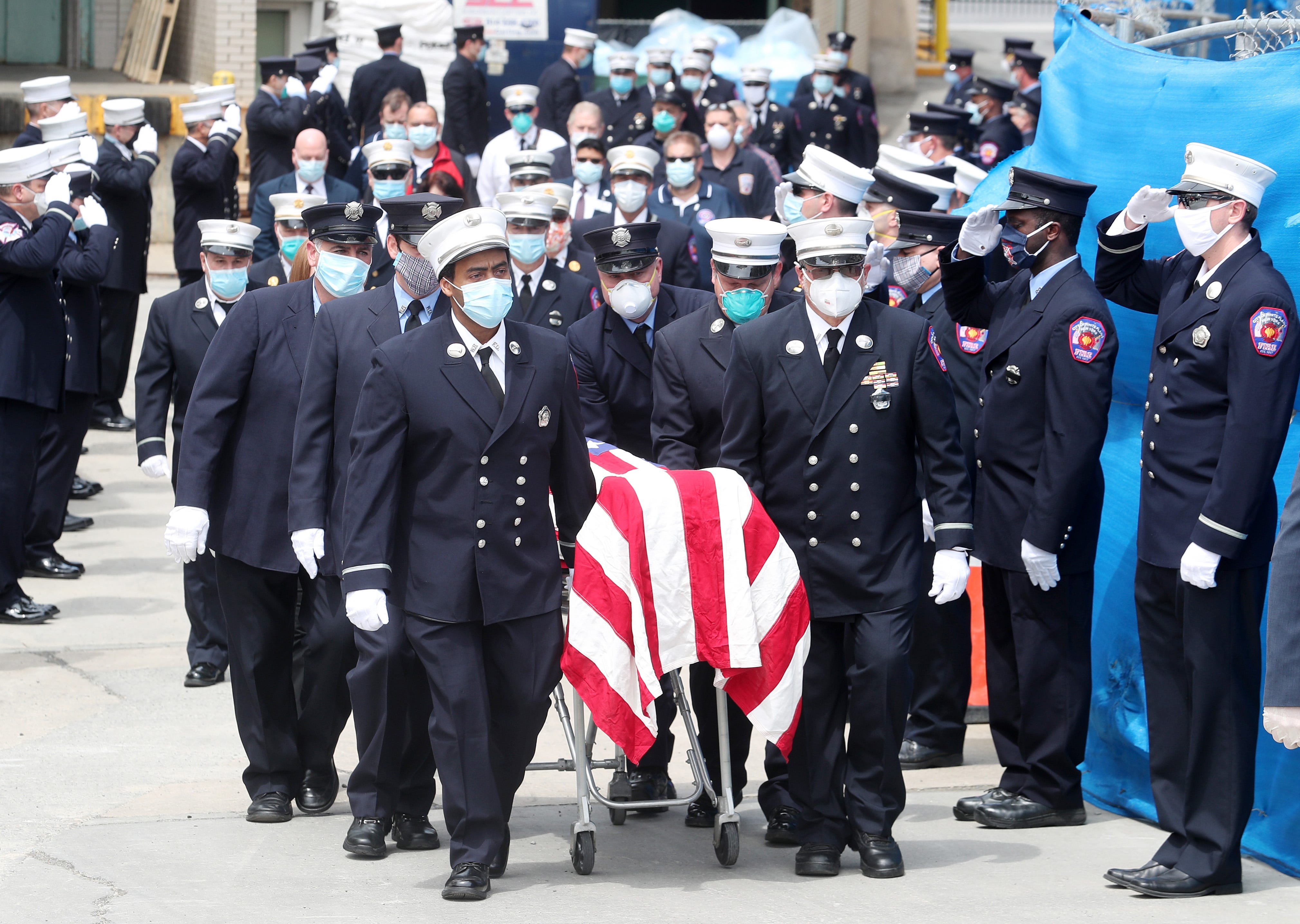 White Plains firefighters carry the flag draped body of their brother Deputy Chief Edward Ciocca from White Plains Hospital May 3, 2020. Ciocca, a 35-year veteran of the White Plains Fire Department, died Saturday due to complications from COVID-19.