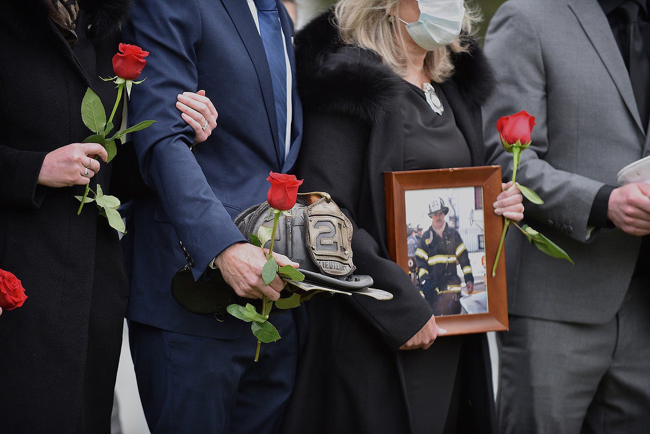 New Rochelle firefighters line up at the cemetery following the funeral of Captain Andy DiMaggio on May 7, 2020. DiMaggio died of complications from the coronavirus.