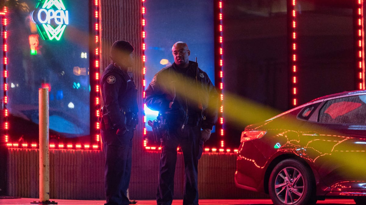 Law enforcement personnel are seen outside a massage parlor where a person was shot and killed on March 16, 2021, in Atlanta, Georgia. Eight people were killed in shootings at three different spas in the US state of Georgia on March 16 and a 21-year-old male suspect was in custody, police and local media reported, though it was unclear if the attacks were related.