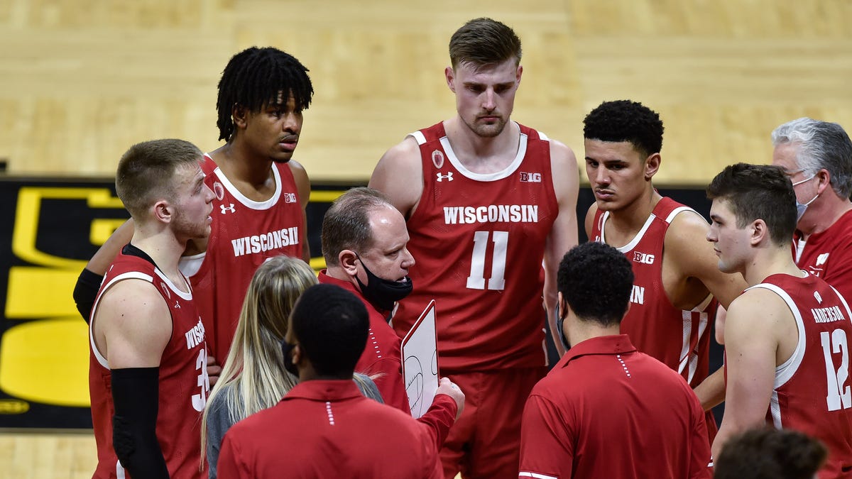 Wisconsin Badgers head coach Greg Gard talks with guard Trevor Anderson (12) and guard Brad Davison (left) and forward Micah Potter (11) late in the game during the second half against the Iowa Hawkeyes at Carver-Hawkeye Arena.
