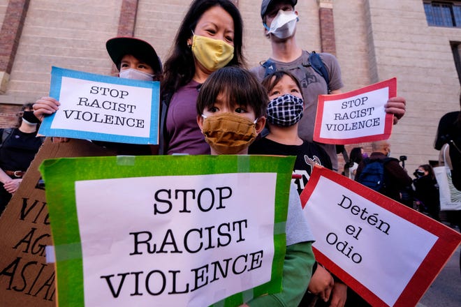 A family attends a rally at the Japan-American National Museum in Little Tokyo, Los Angeles, California, on March 13, 2021 to raise awareness of anti-Asian violence.