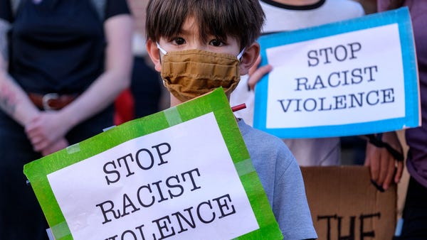A boy takes part in a rally in a rally to raise aw