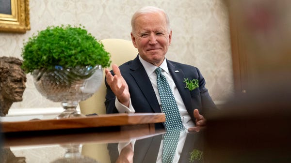 President Joe Biden sits next to a bowl of Irish s