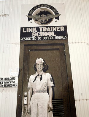 Navy Veteran Priscilla Getchell shown in front of a Link Trainer School.