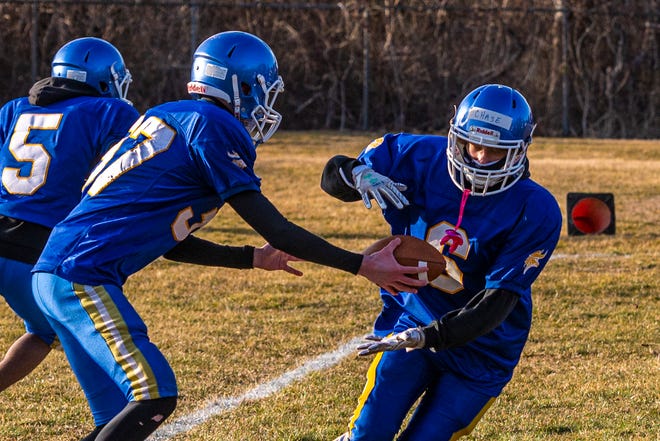 Elijah Carrion hands the ball off to Chase Colon during Wareham's preseason training.