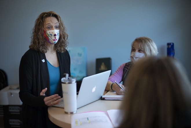 Diane Crawford, left, founded The Crawford Crew, a nonprofit group that raises awareness and educates people about preventing cervical cancer, three months after her diagnosis in 2009 and in this photo meets with her board chairwoman, Kay Knoll, center, and board treasurer Theresa Mason inside their Westerville office.