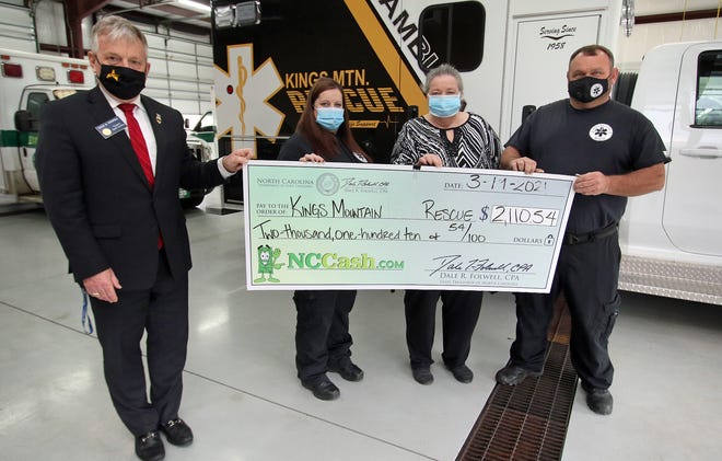 North Carolina State Treasurer Dale Folwell presents a check to Shannon Bell, Donna Rose and John Harris Friday afternoon, March 19, 2021, at the Kings Mountain Rescue building in Kings Mountain.