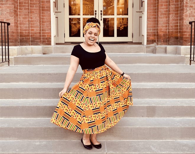 Myya Helm, a 21-year-old student at West Virginia University, poses on campus. Helm said that when lawmakers focus on preserving Confederate monuments over a bill meant to end discrimination based on Black hairstyles, she feels an even stronger push to leave the state.