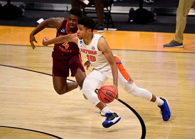Florida Gators guard Noah Locke (10) dribbles against Virginia Tech Hokies guard Nahiem Alleyne (4) during the first round of the NCAA Tournament on Friday, March 19, 2021, at Hinkle Fieldhouse in Indianapolis.