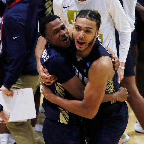 Oral Roberts players celebrate after the upset.