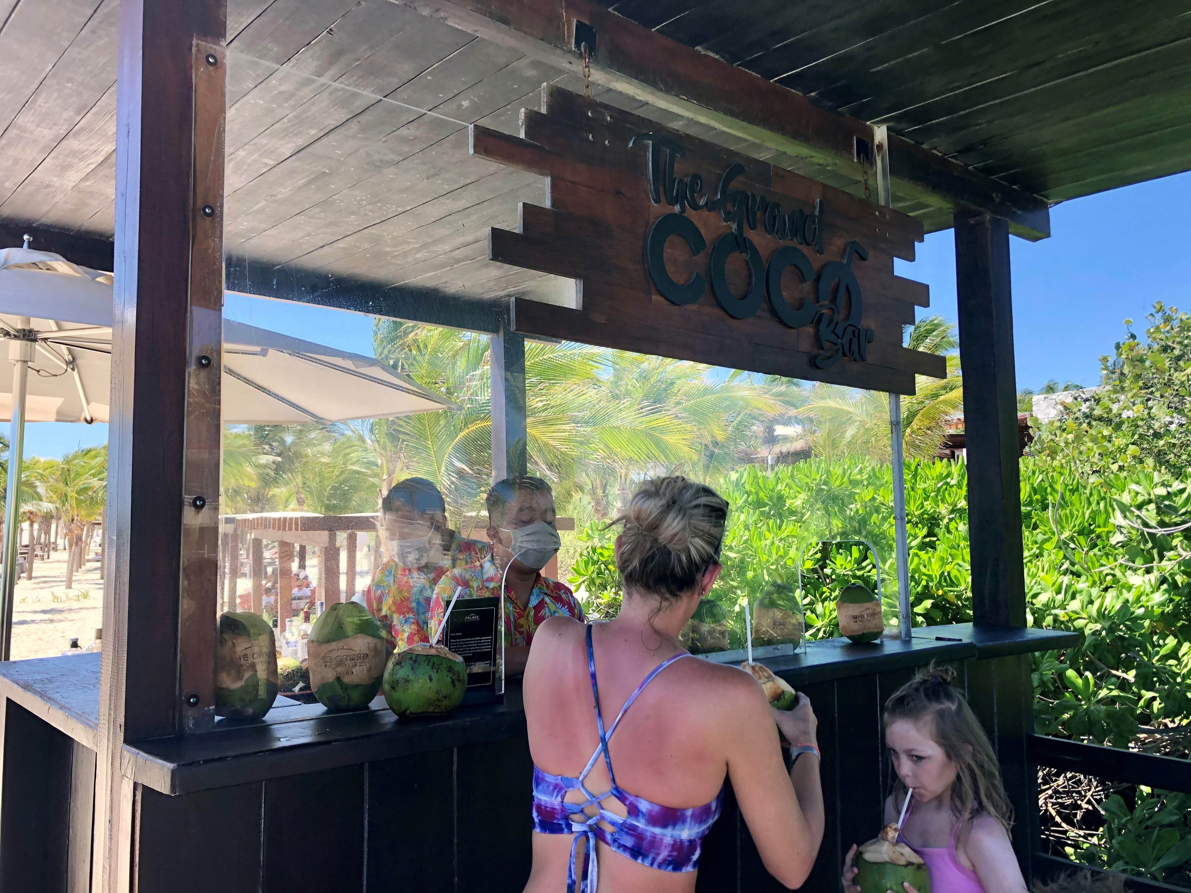 Guests at The Grand at Moon Palace, a luxury resort in Cancun, Mexico, are treated to complimentary drinks in souvenir coconuts.  The resort has been serving as many as 400 a day, back to pre-pandemic levels.