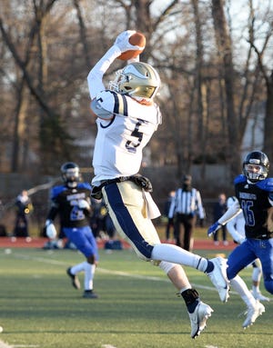 East Bridgewater's  Shane Graham makes the interception catch and scores a touchdown during a game versus Randolph, on Friday, March 19, 2021.     