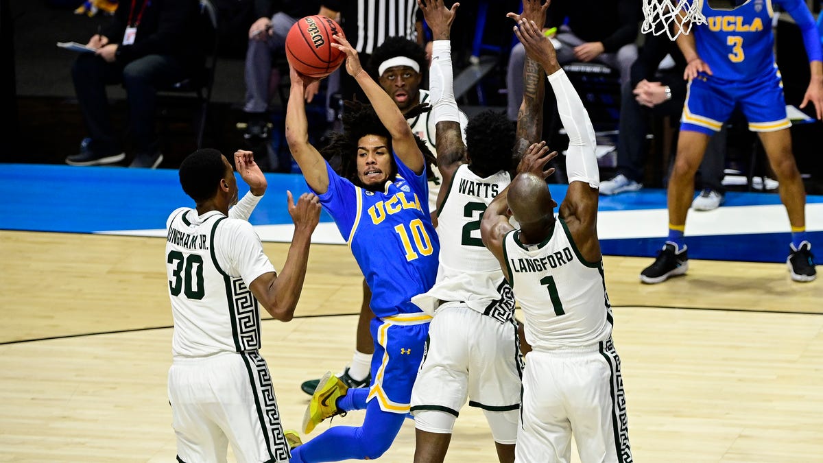 UCLA guard Tyger Campbell (10) controls the ball against Michigan State during the second half of their First Four game of the 2021 NCAA Tournament at Mackey Arena.
