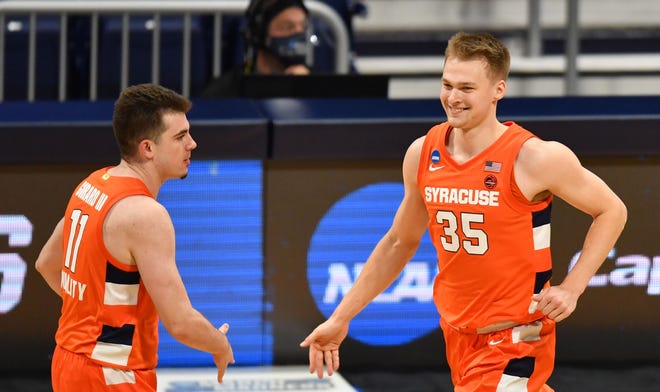Syracuse Orange guard Buddy Boeheim (35) celebrates with guard Joseph Girard III (11) against the San Diego State Aztecs during the first round of the 2021 NCAA Tournament at Hinkle Fieldhouse.