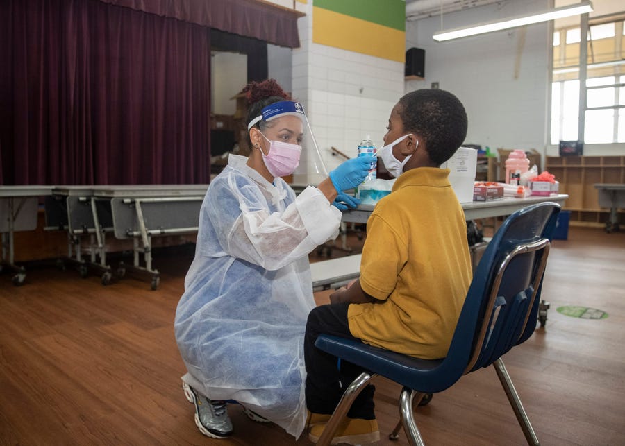 Medical assistant Rena Young administers a COVID-19 test to a student at the Libertas School of Memphis on Thursday, March 18, 2021.    