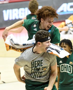 Ohio guard Jason Preston jumps over teammates following their win over Virginia in the first round of the NCAA Tournament on Saturday, March 20, 2021, at Assembly Hall in Bloomington, Ind.