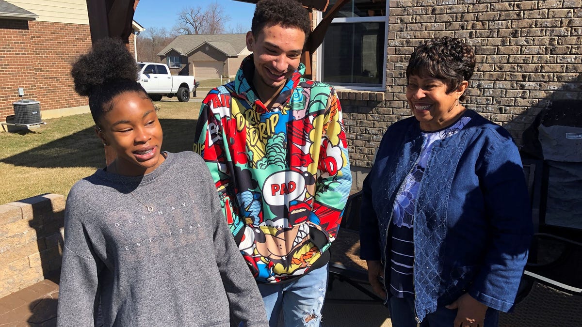 Brilee Carter, left,13, and Cobe Calhoun, 17, share a laugh with their great-grandmother, Doris Rolark, outside Rolark's daughter's home on March 7, 2021, in Monroe, Ohio. The pandemic and its isolating restrictions have been especially tough for many of the nation's some 70 million grandparents, many at ages when they are considered most vulnerable to the deadly COVID-19 virus. Rolark, of Middletown, Ohio, has always been active with the offspring. She   raised three children mostly on her own, had five grandchildren (two now deceased), and has helped a lot with some of her 16 great-grandchildren.