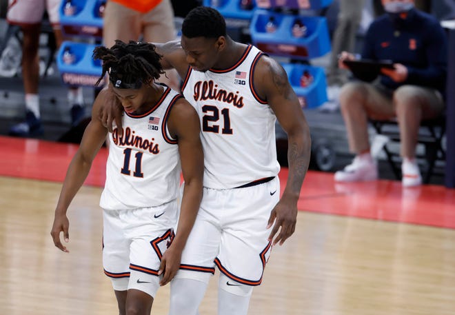 Illinois guard Ayo Dosunmu (11) is comforted by center Kofi Cockburn (21) during their second-round to Loyola Chicago.