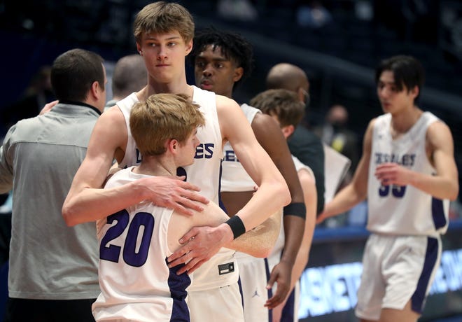 Atticus Schuler of DeSales consoles teammate Austin Mann (20) after the Stallions were beaten 72-50 by Akron St. Vincent-St. Mary in the Division II state championship game Sunday.