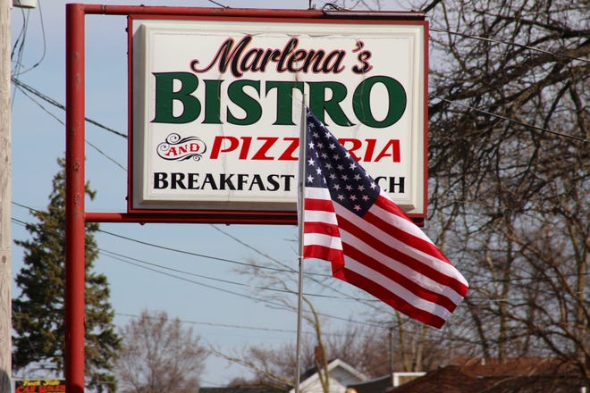 Supporters of Marlena Pavlos-Hackney, owner of Marlena's Bistro & Pizzeria, gather at her restaurant Monday, March 22, awaiting a news conference organized by local state Republican legislators. The restaurant was closed Friday, March 19, following Pavlos-Hackney's detainment for violating a court order.