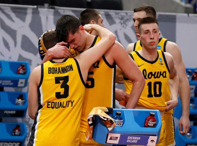 Jordan Bohannon, left, and Luka Garza embrace as the final seconds tick down in Iowa's 95-80 loss to Oregon.