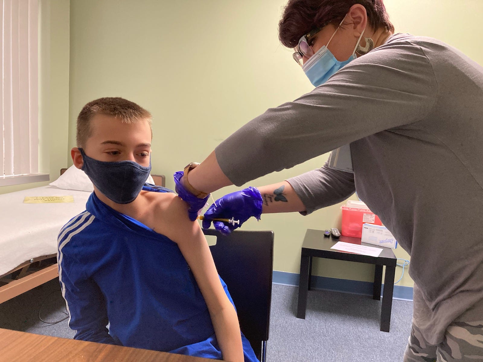 Nicky Byers, 12, of Oldham County, gets his first COVID-19 vaccination during a Moderna drug trial to test the vaccine on kids 12 and older. Jan. 25, 2021