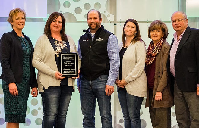 Julie Maurer, Newton, Wis., holding plaque, was honored with the 2021 PDPW Dean Strauss Memorial Award. The honor was presented March 18 during the PDPW Business Conference. Joining her from left are, l-r: Shelly Mayer, PDPW Executive Director, Strauss’s brother, wife and parents: Darin Strauss, Kris Strauss, and Sandy and Ed Strauss.