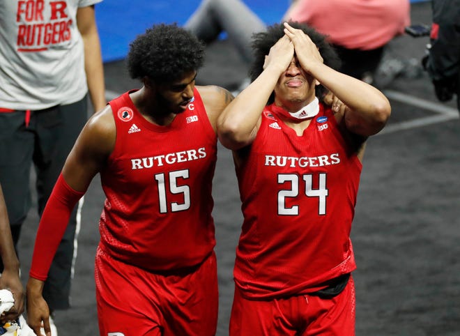 Rutgers Scarlet Knights center Myles Johnson (15) consoles teammate Ron Harper Jr. (24) after a loss to Houston during the second round of the 2021 NCAA Tournament on Sunday, March 21, 2021, at Lucas Oil Stadium in Indianapolis, Ind.