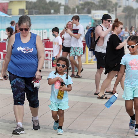 Families and young adults pack the boardwalk, Tues