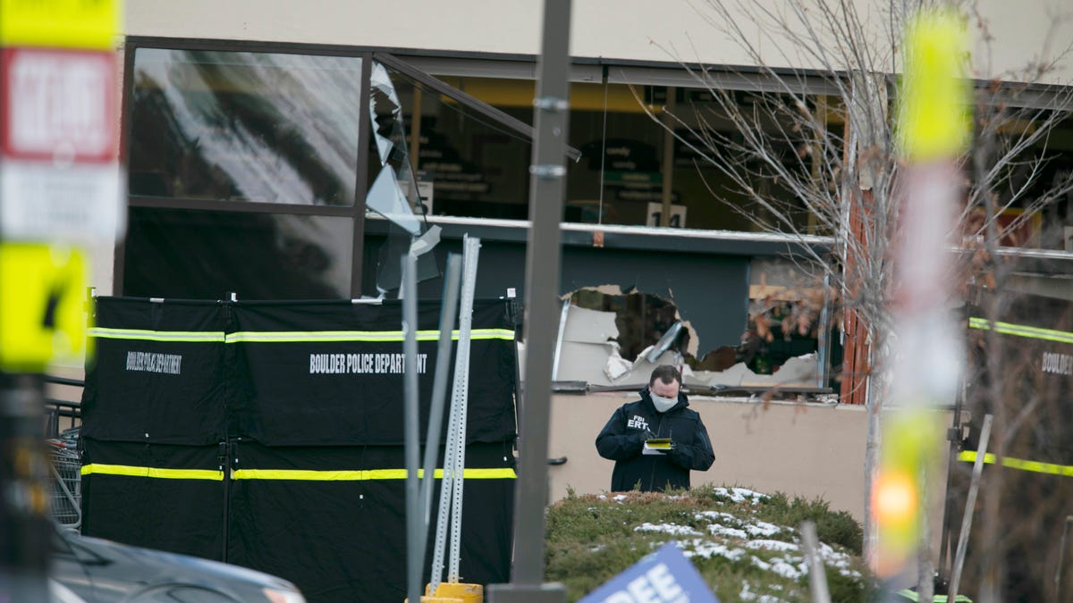 Police work on the scene outside of a King Soopers grocery store where multiple people were killed in a shooting, Monday, March 22, 2021, in Boulder, Colo.