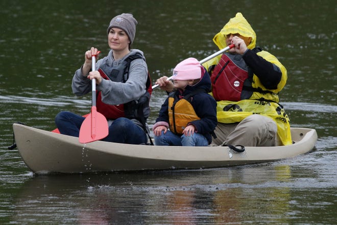 Shauri and Scott Bair and their daughter Nellie 5, make their way back to shore while riding in a canoe, during the 2019 Youth Jamboree, Saturday May 11, 2019 at Big Hollow Recreation Area near Sperry. The Jamboree a cooperative effort by wildlife and conservation organizations featured a variety of family-oriented outdoor activities. 