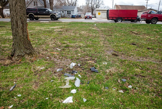 Debris is left behind from a car that struck a tree in Bergen Park Golf Course after the driver was shot leaving the drive-thru of The Crossing Too, a discount liquor and tobacco store, in the 2800 block fo Clear Lake Avenue in Springfield, Ill., Wednesday, March 24, 2021. The driver of the car, James Simpson Jr. of Springfield, died from multiple gunshot wounds and a passenger, a 20-year-old male, was transported to HSHS St. John's Hospital with a wound to his back. [Justin L. Fowler/The State Journal-Register] 